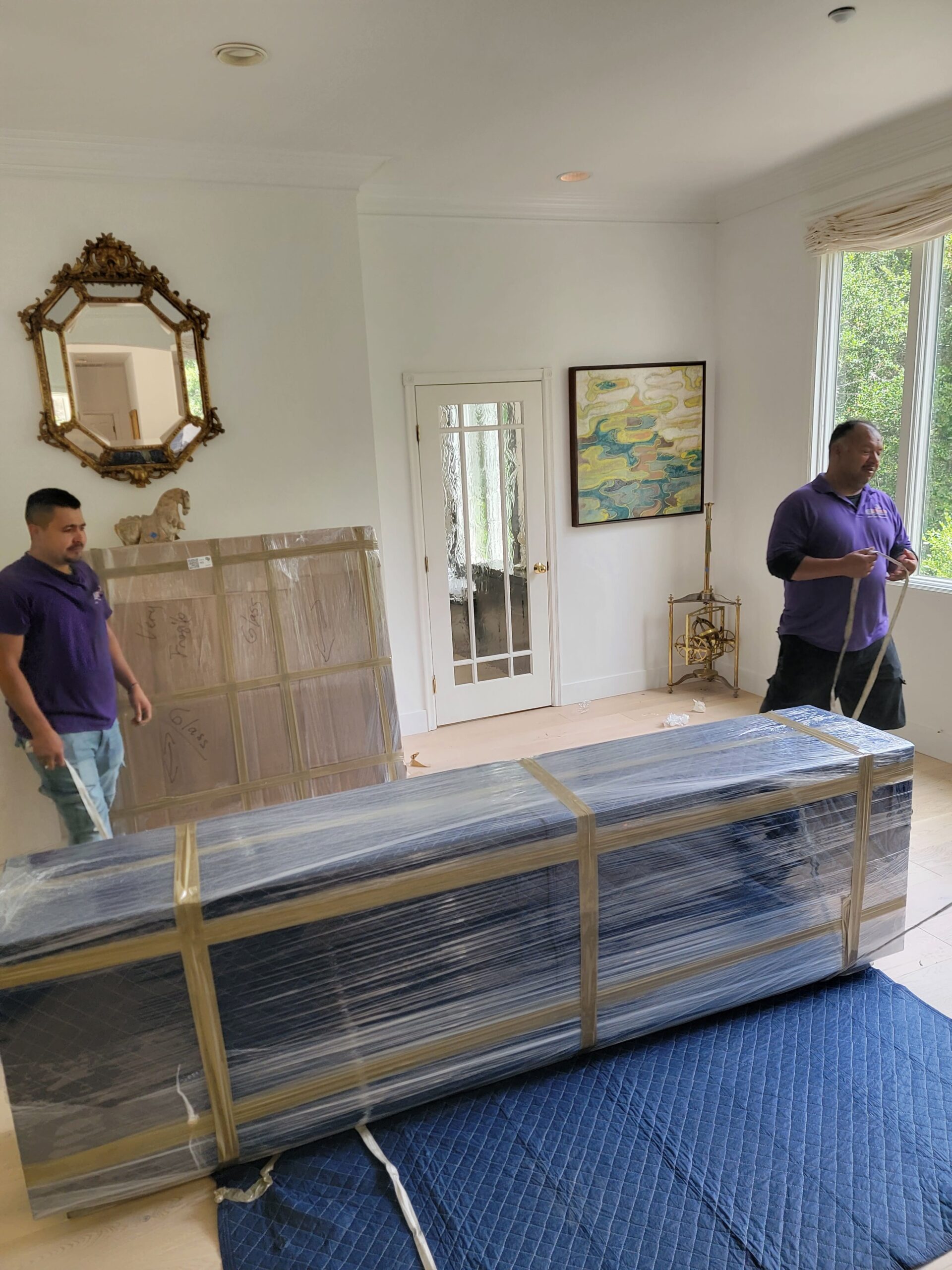 Home staging movers arranging furniture for a San Carlos property listing
