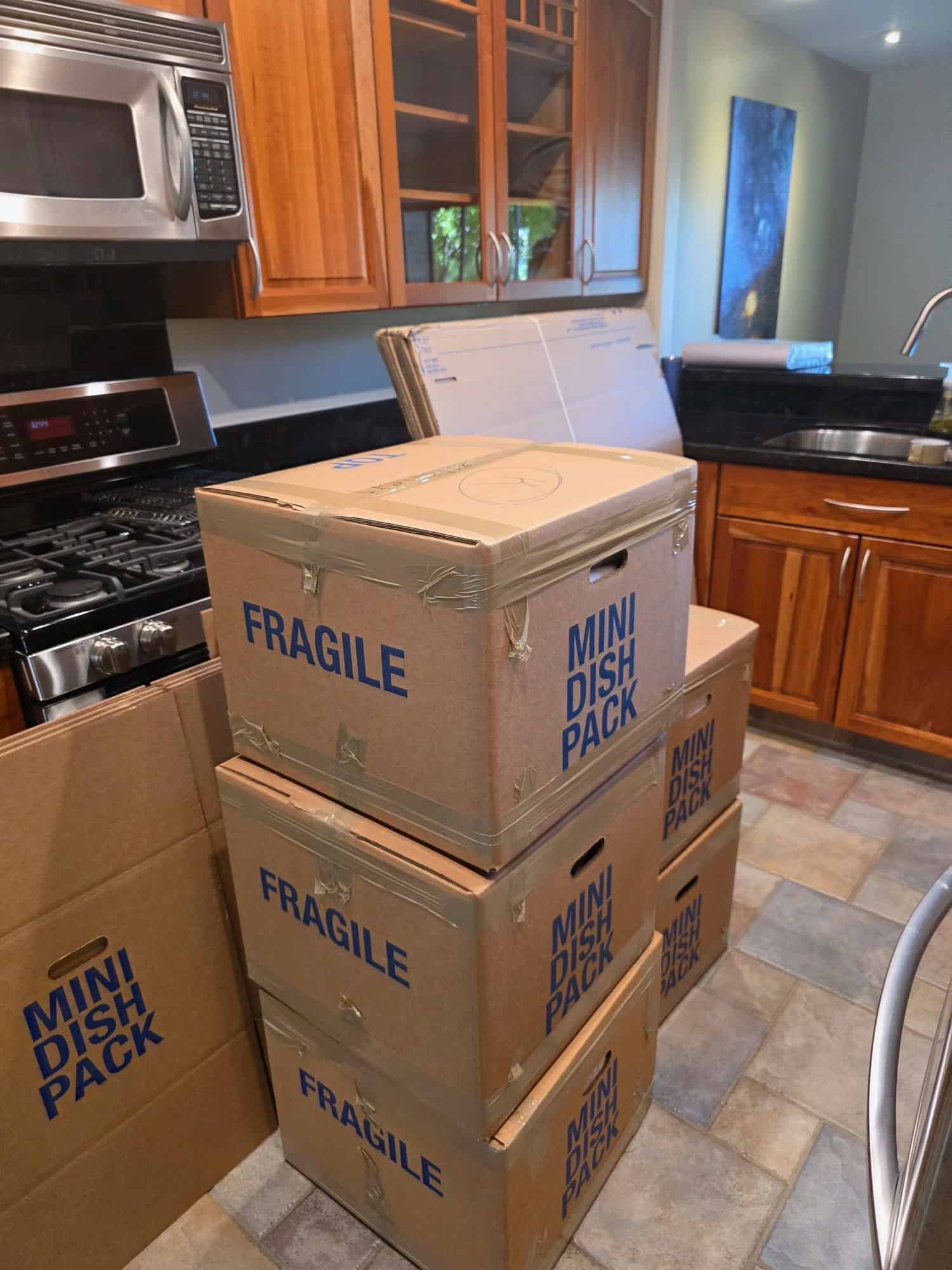 Professional movers handling large kitchen appliances in San Carlos